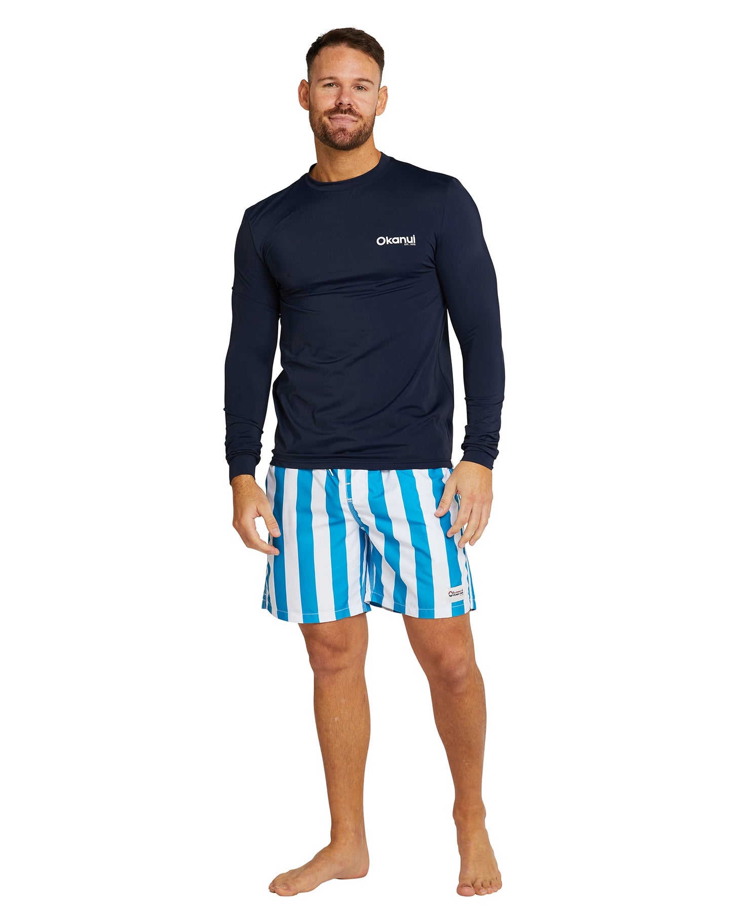 The Okanui Men's Spring Long Sleeve Rashie in navy color partner with Okanui blue printed shotr.