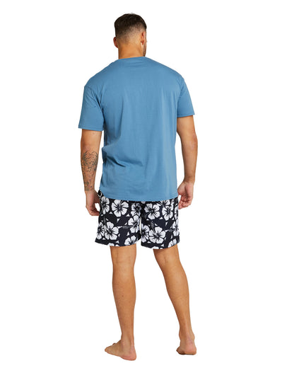 The Okanui Mens Swimshorts in black colour pairs perfectly with a blue t-shirt worn by a male model.