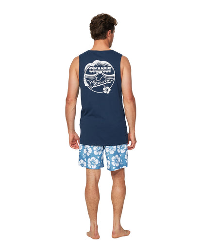 A farther back view of a male model wearing the Okanui Classic Badge Tank Top for men in navy colour.