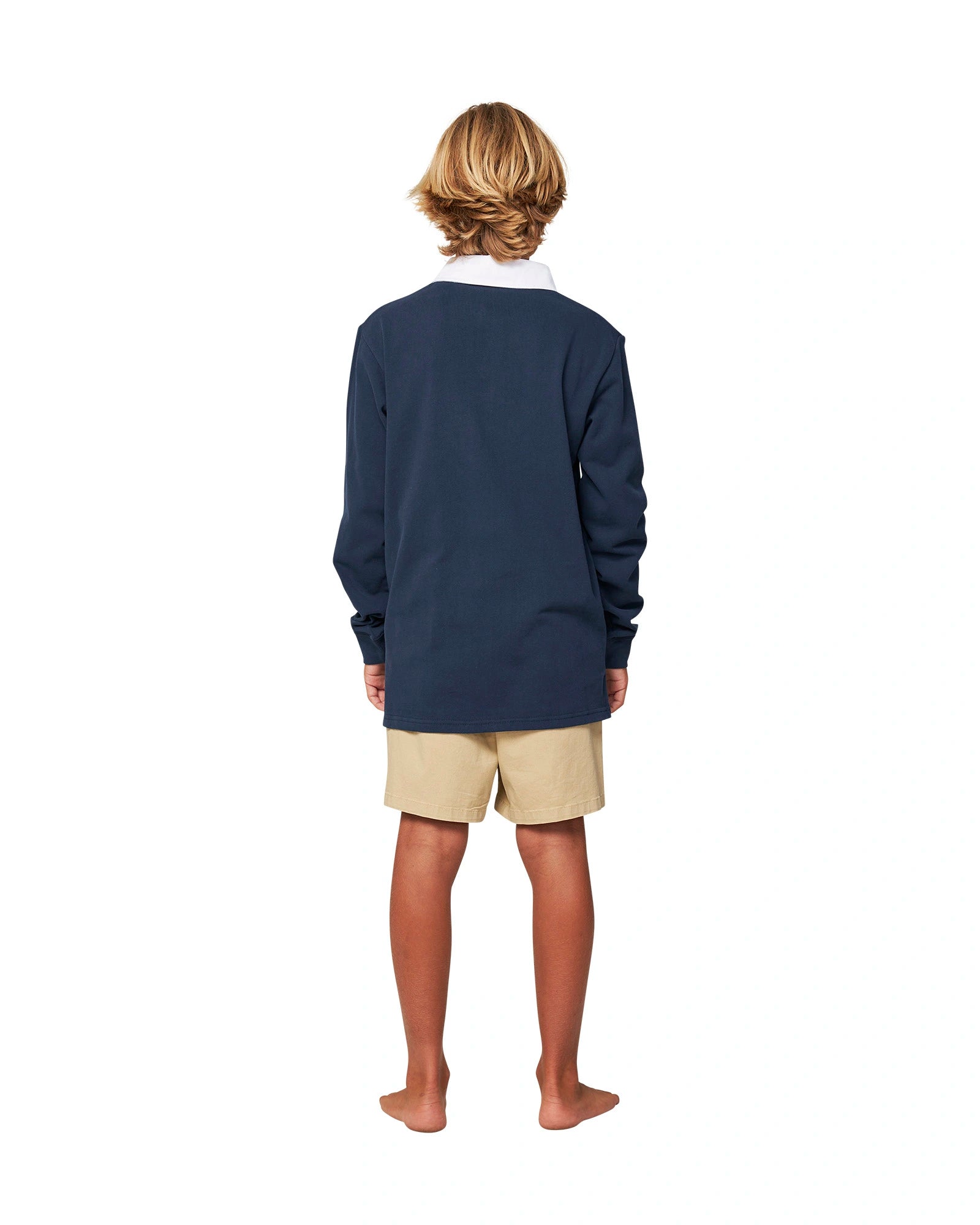 Full body back view of a boy wearing the Okanui Heritage long sleeve rugby tops and jumpers in Navy