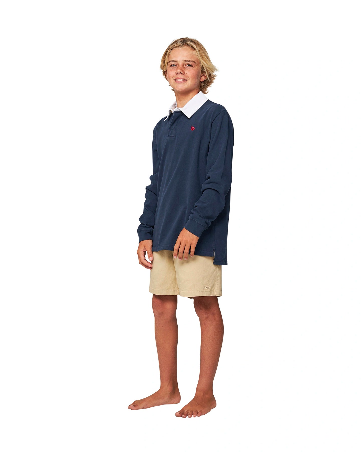 Full body front view of a boy wearing the Okanui Heritage long sleeve rugby tops and jumpers in Navy