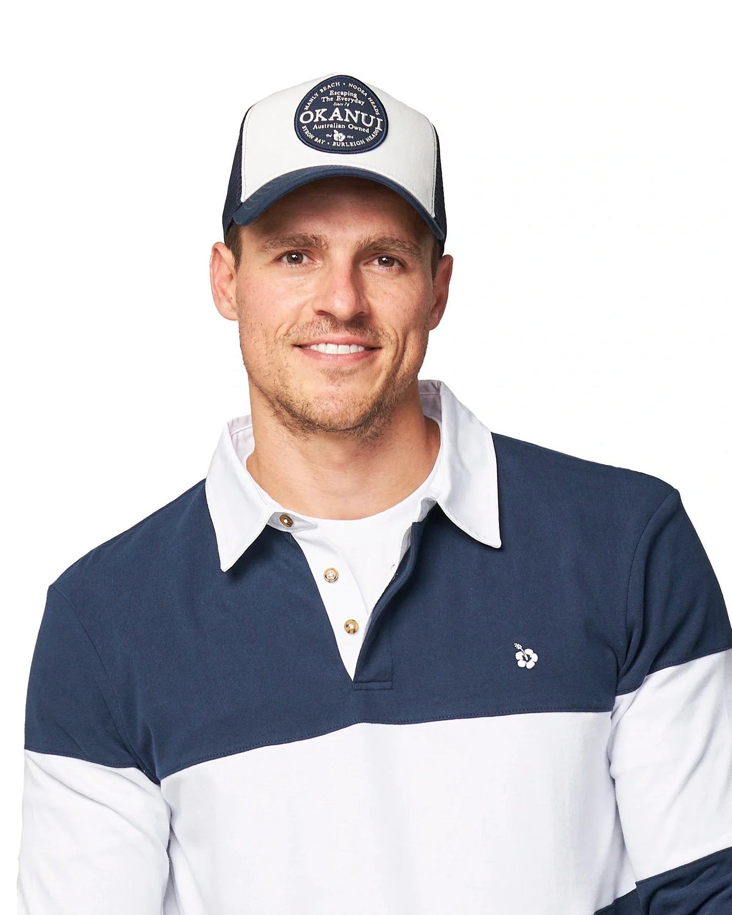 Front view of a male model wearing the Okanui All day trucker cap with mesh back features