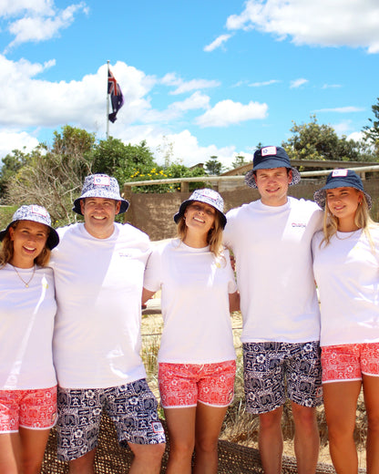 A group of adults in white shirts wearing the Okanui reversible bucket hat Gotcha4Life