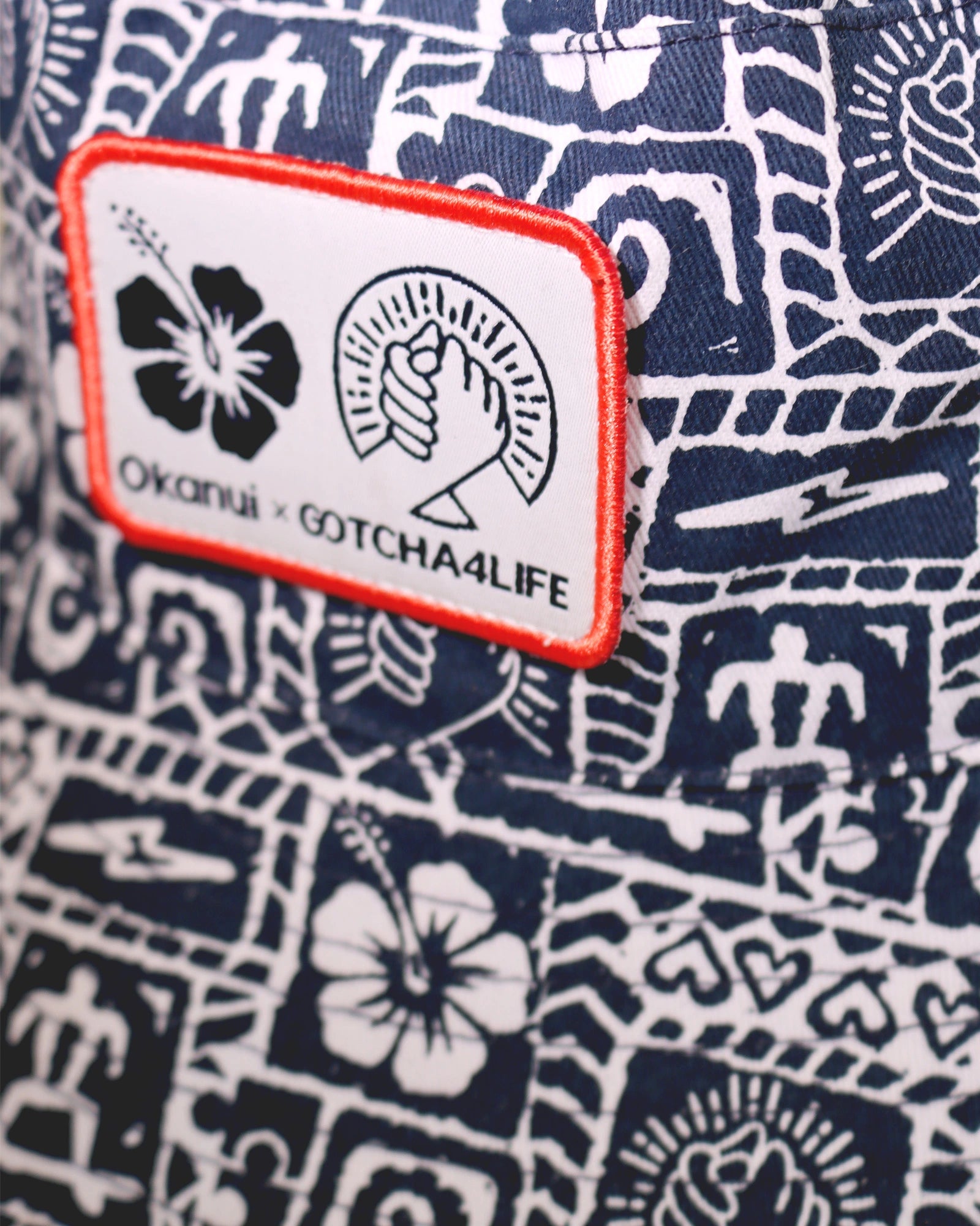 Close up details of the Okanui reversible bucket hat Gotcha4Life badge