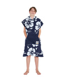 Front view of a boy with his hand on the pocket of Okanui Hooded Towel in Hibiscus Navy color