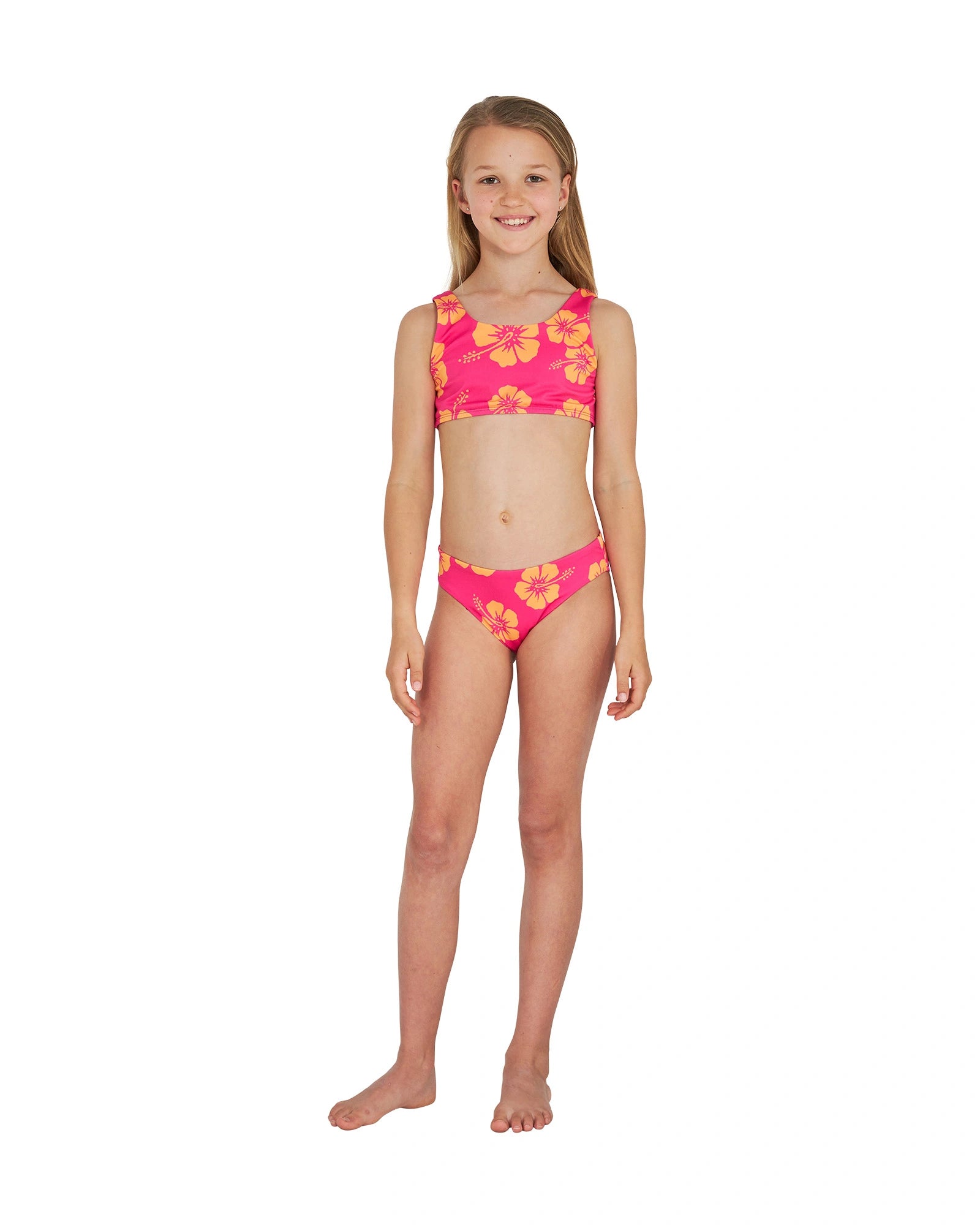 Full body front view of a girl wearing the Okanui crop bikini set in Hibiscus Pink Melon