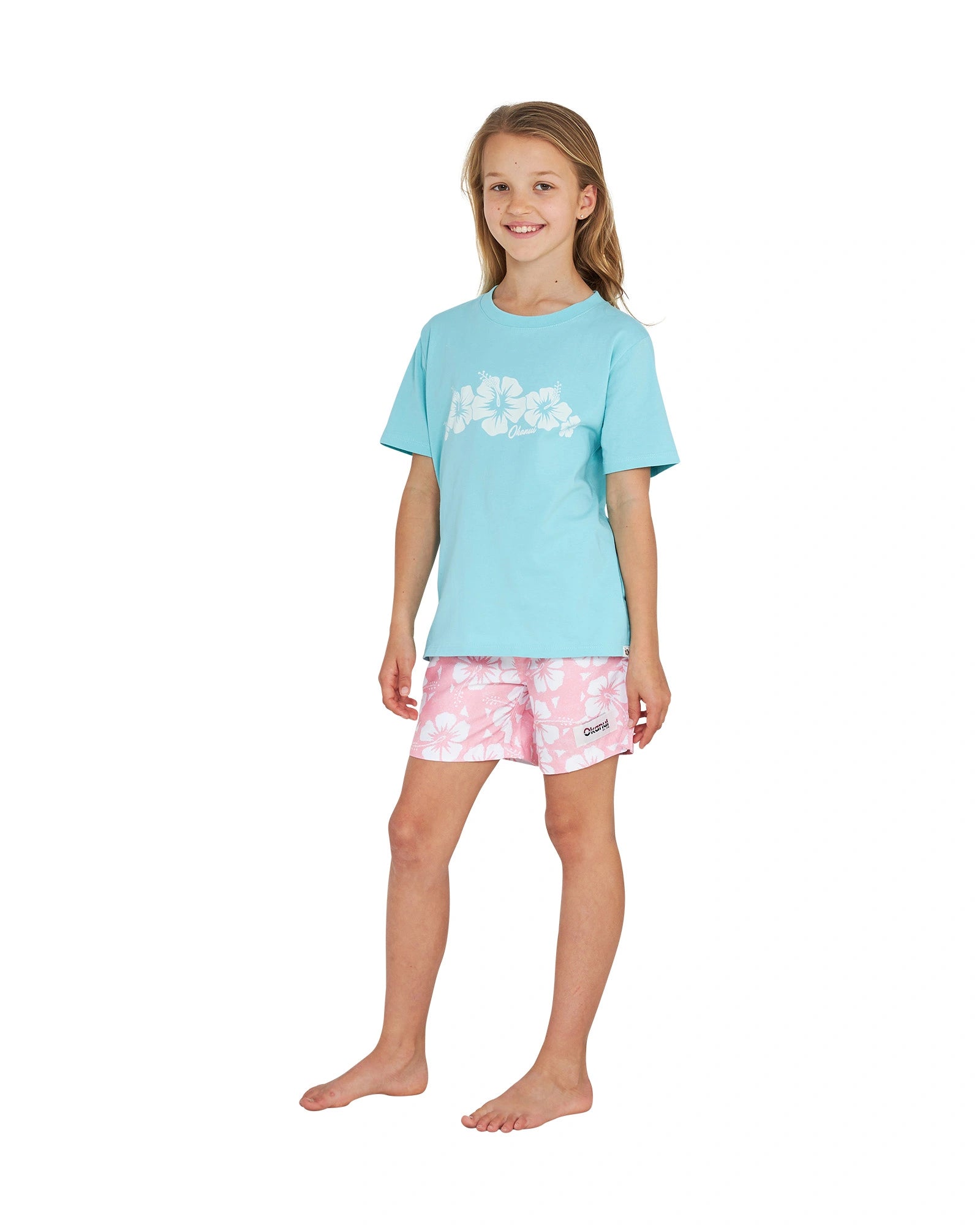 Full body front view of a girl wearing the Okanui Logo Tee T-shirt in Washed Aqua