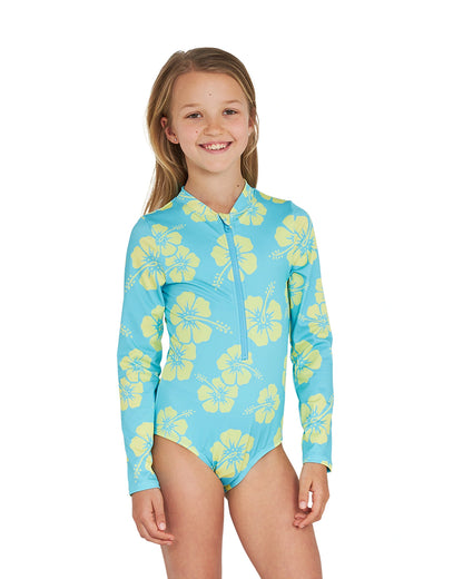 One leg stand pose of a girl wearing the Okanui long sleeve one piece swimsuit for girls in Hibiscus Aqua Yellow