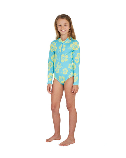 Angled front view of a girl wearing the Okanui long sleeve one piece swimsuit for girls in Hibiscus Aqua Yellow