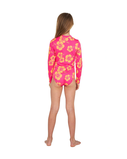 Full body back view of a girl wearing the Okanui long sleeve one piece bikini swimsuit for girls in Hibiscus Pink Melon