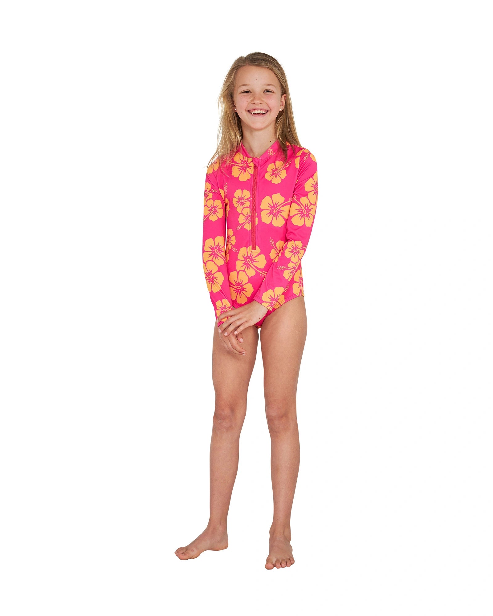 Full body front view of a girl wearing the Okanui long sleeve one piece bikini swimsuit for girls in Hibiscus Pink Melon