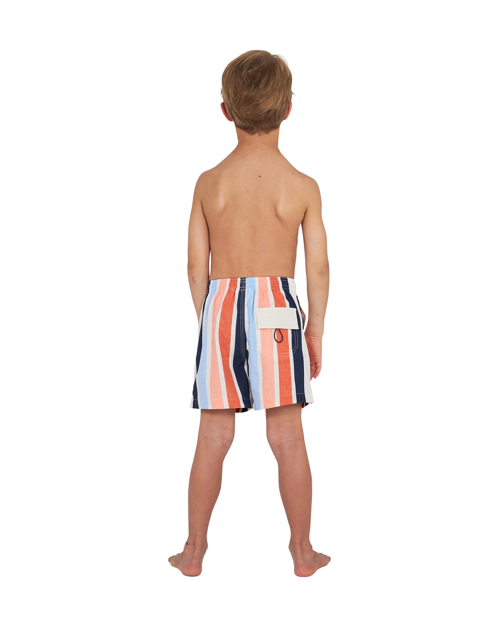 Full body of a topless little boy wearing the Okanui stretch swim shorts in Birch Multi