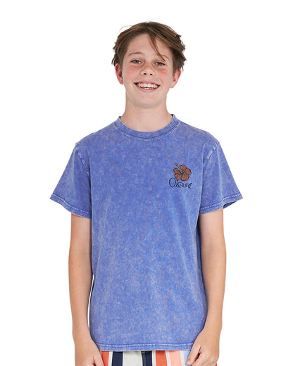 Closeup front view of a boy wearing the Okanui Good Company Tee T-shirt in Washed Blue