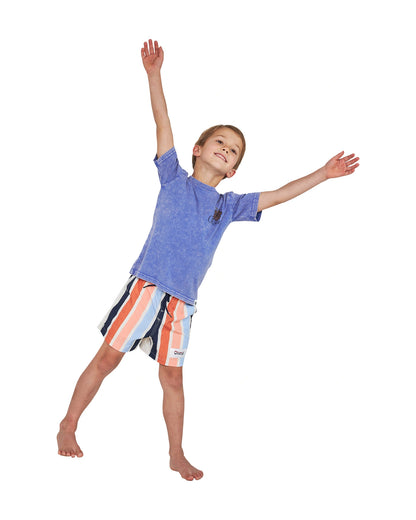 Joyful pose of a little boy wearing the Okanui Good Company Tee T-shirt in Washed Blue