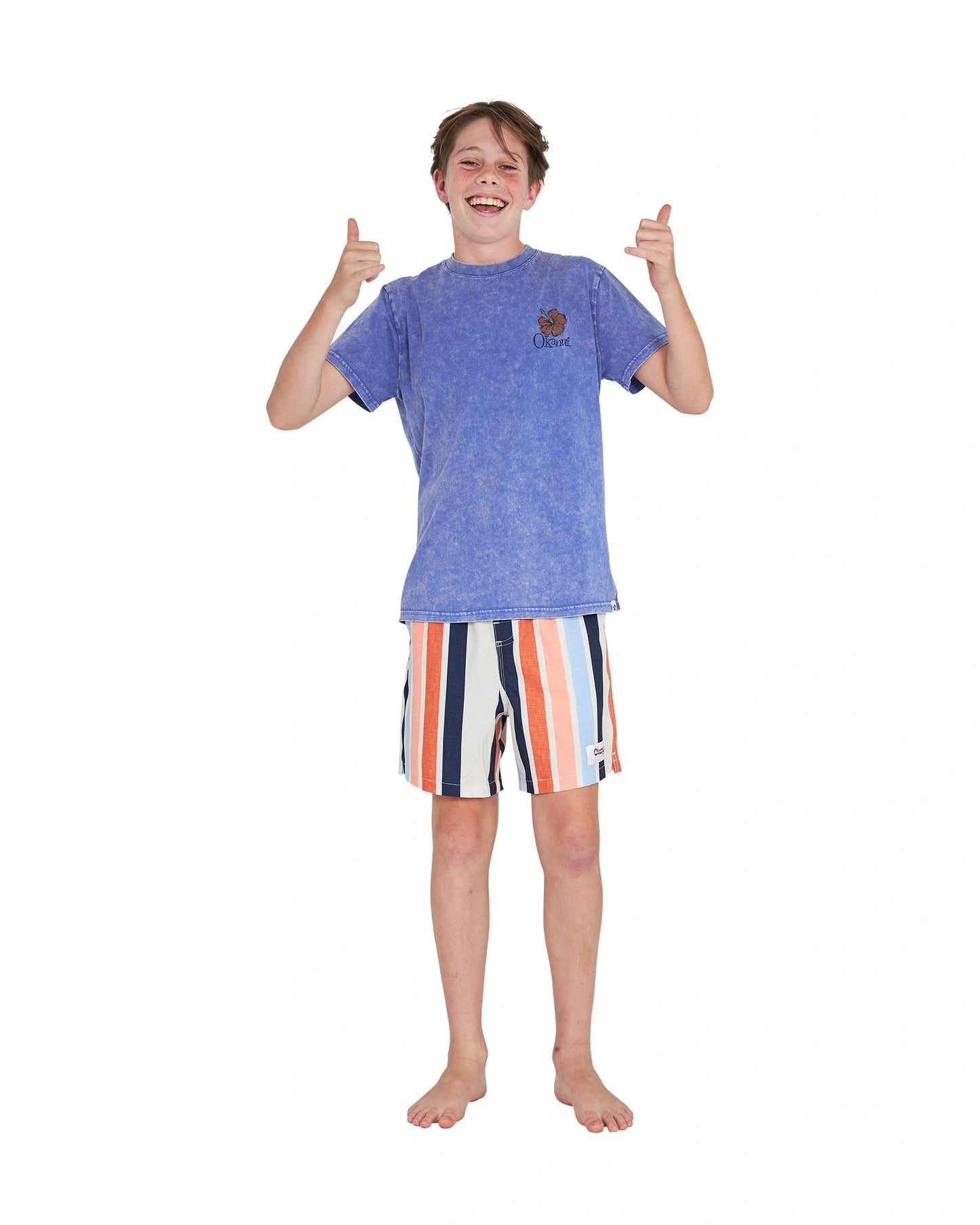 Thumbs up pose of a boy wearing the Okanui Good Company Tee T-shirt in Washed Blue