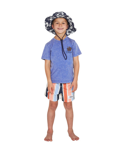 Full body front view of a little boy in bucket hat paired with the Okanui Good Company Tee T-shirt in Washed Blue