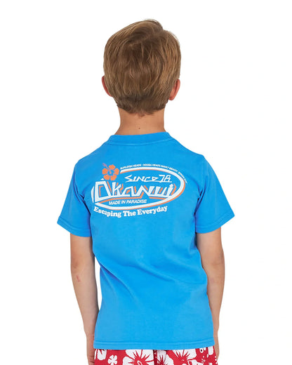 Closeup back view of a little boy wearing the Okanui Point Break Tee T-shirt in Washed Blue