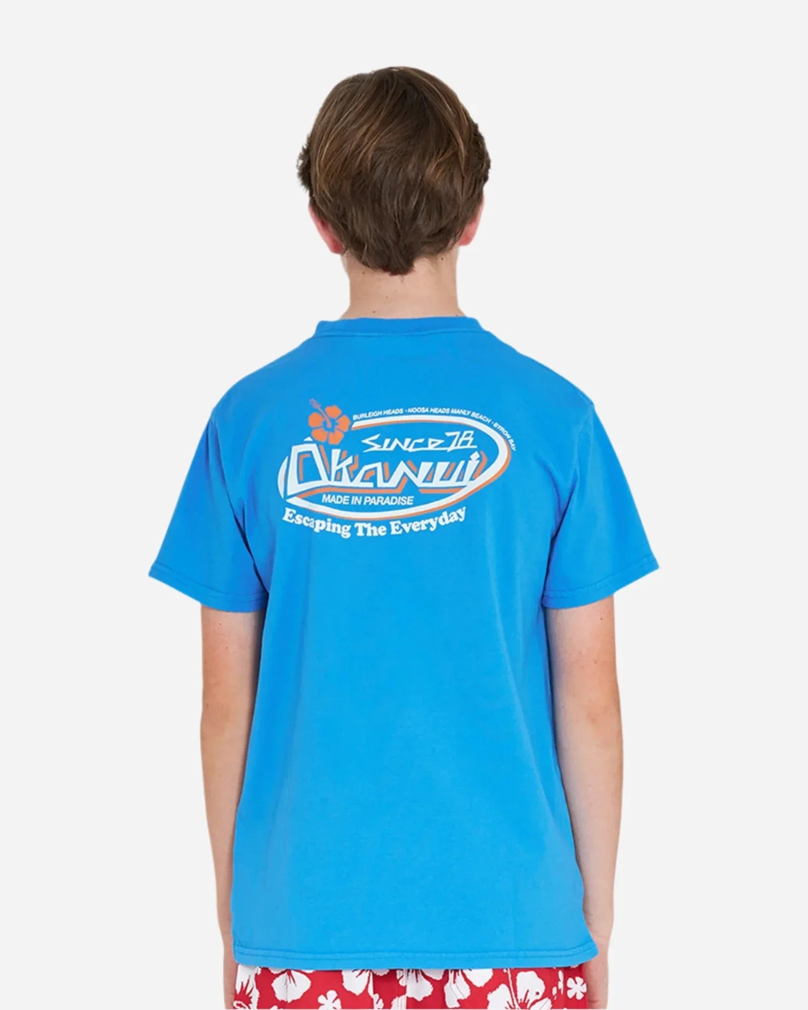 Back view of a boy wearing the Okanui Point Break Tee T-shirt in Washed Blue