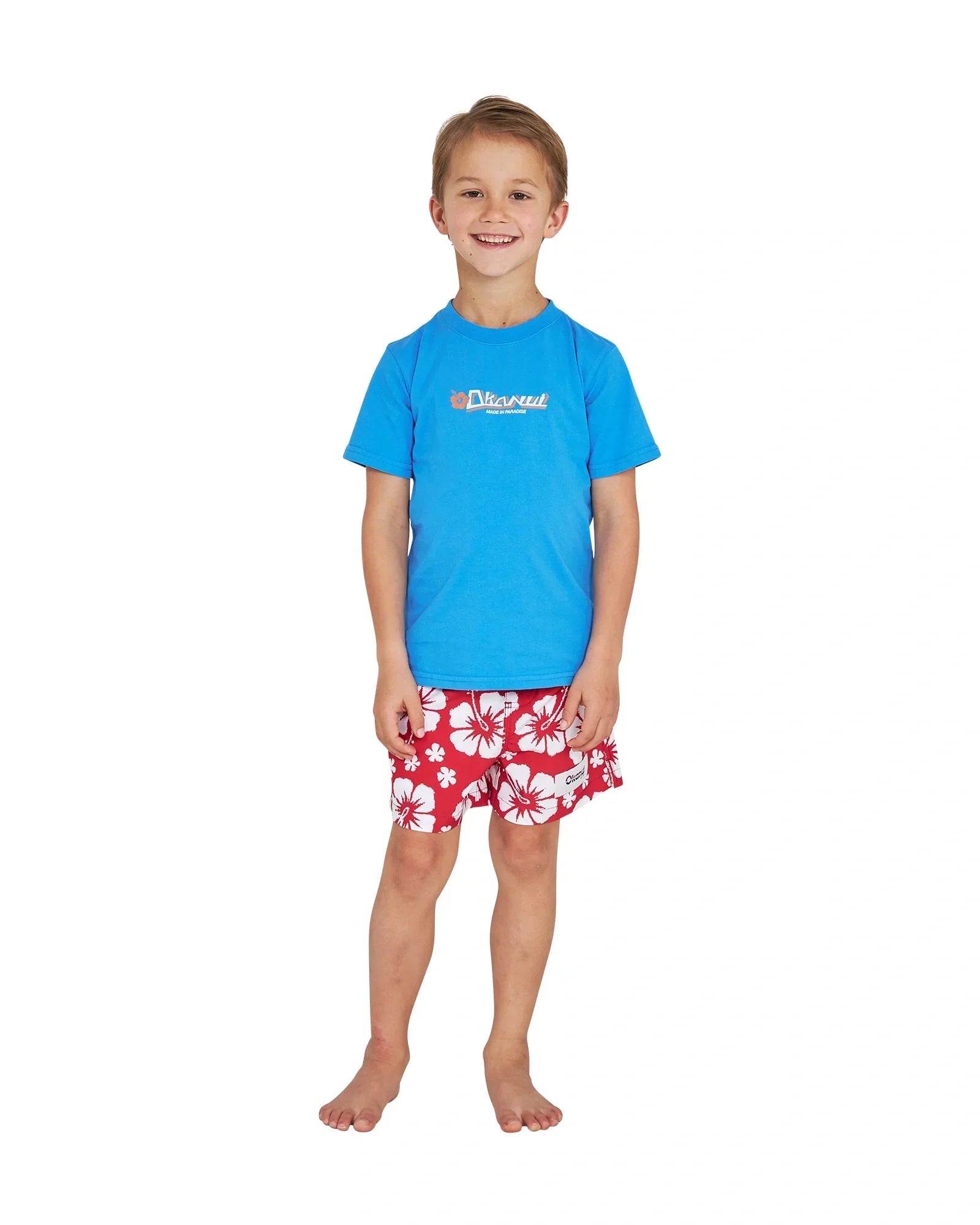 Full body front view of a little boy wearing the Okanui Point Break Tee T-shirt in Washed Blue