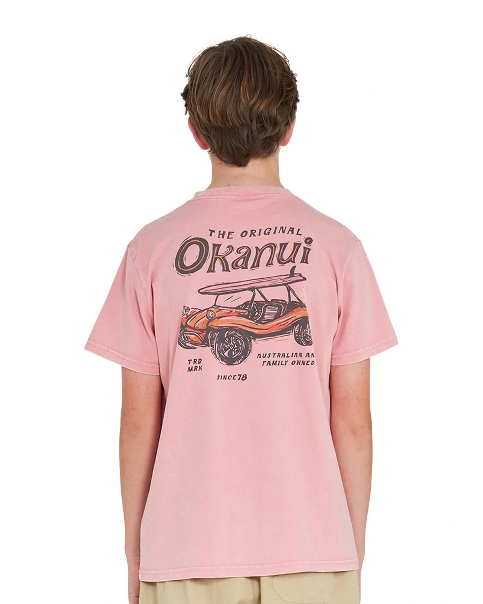 Back view of a boy wearing the Okanui boys terrain Tee T-shirt in Washed Pink