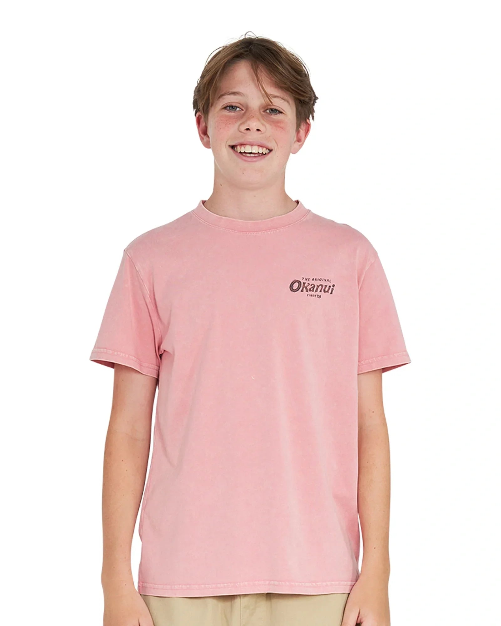 Front view of a boy wearing the Okanui boys terrain Tee T-shirt in Washed Pink