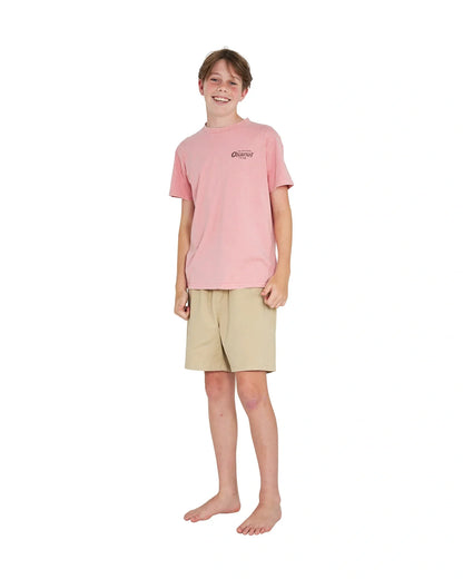 Full body front view of a boy wearing the Okanui boys terrain Tee T-shirt in Washed Pink
