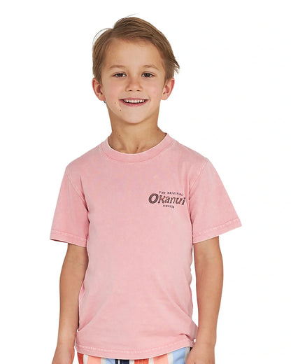 Closeup front view of a little boy wearing the Okanui boys terrain Tee T-shirt in Washed Pink