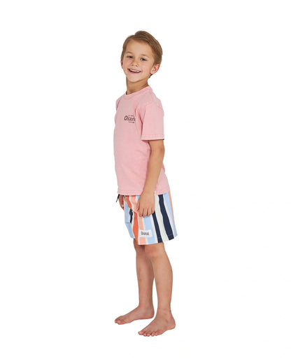 Left Side view of a little boy wearing the Okanui boys terrain Tee T-shirt in Washed Pink