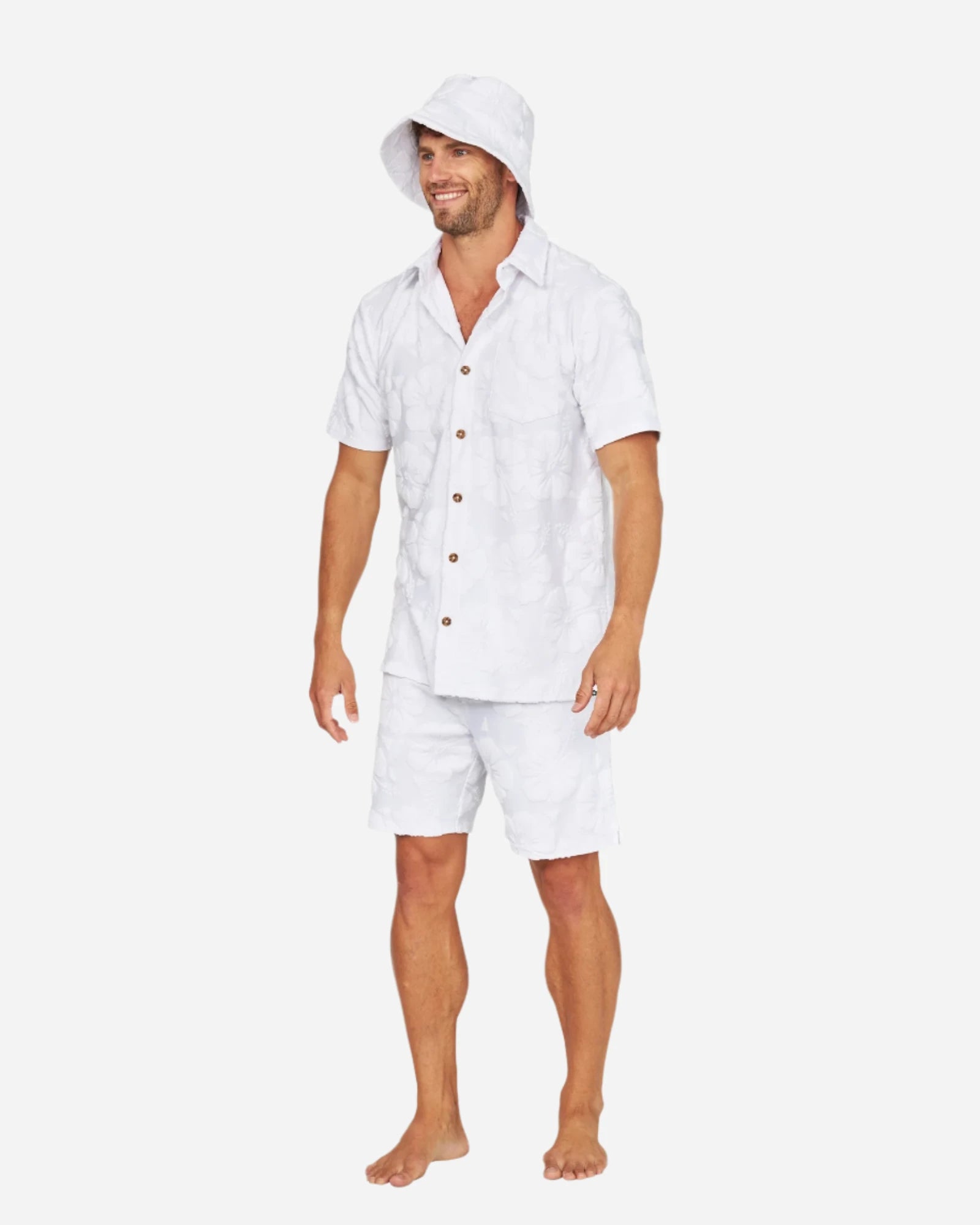 A male model in button up shirt wearing the Okanui Weekender Terry Bucket Hat Hibisicus White