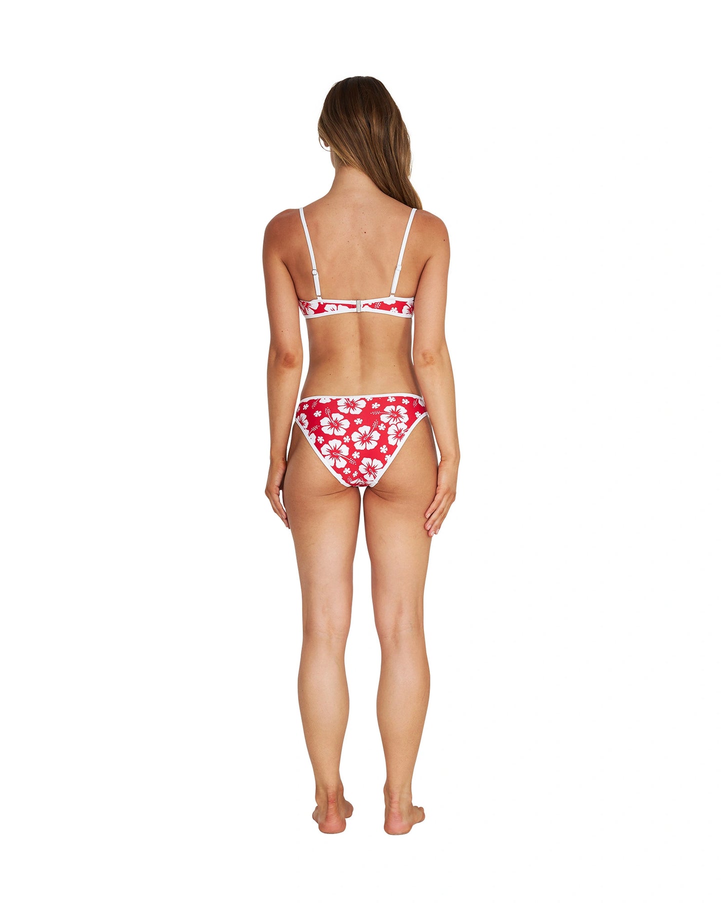 A woman wearing a two-piece bikini in hibiscus red showing the back details. 