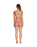 A woman wearing a two-piece bikini in hibiscus red showing the back details. 