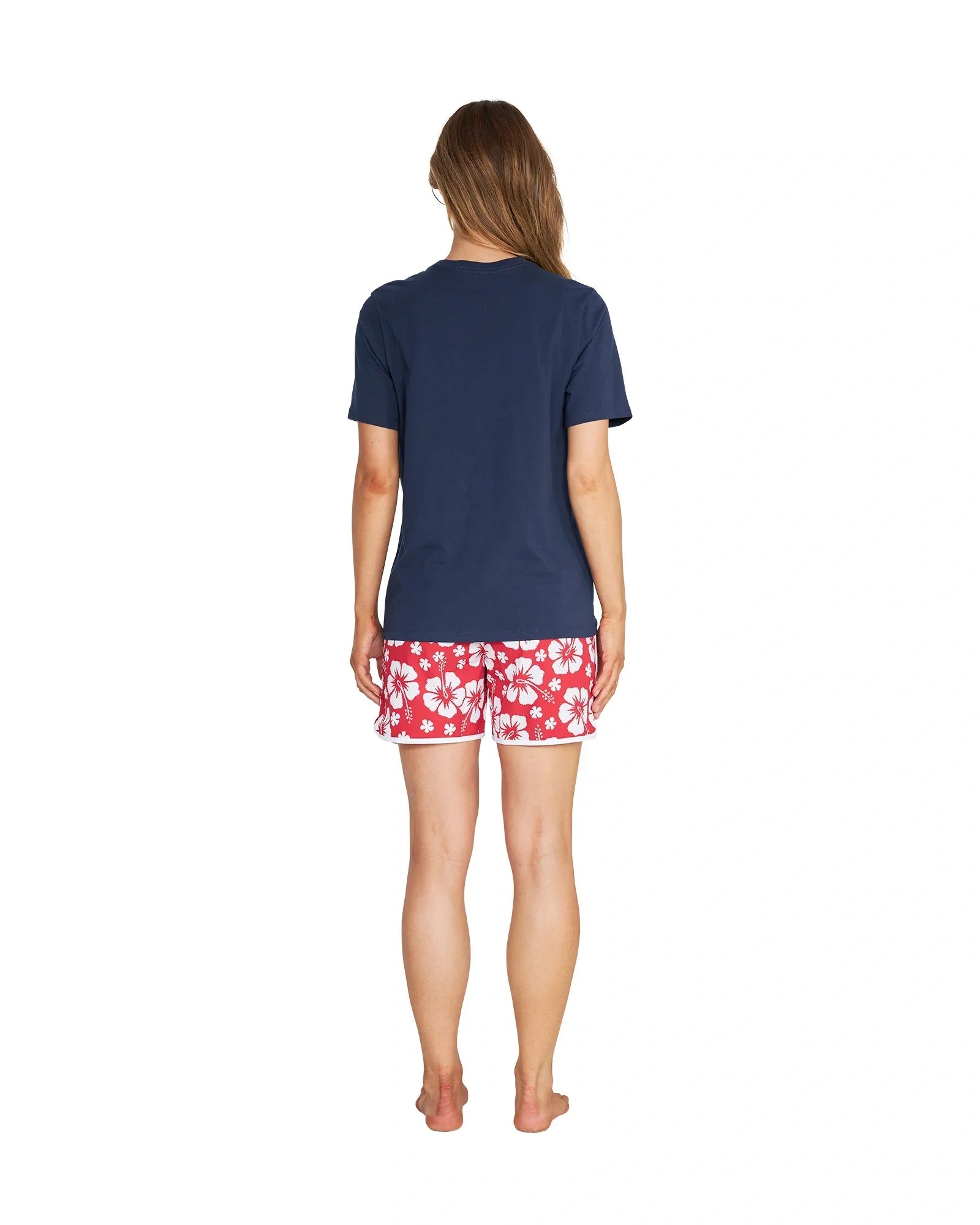 Back view of a female model wearing the Okanui Inline cotton T-Shirt in Navy color
