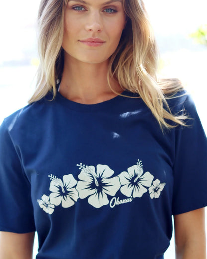 Close up front view of a female model wearing the Okanui Inline cotton T-shirt in Navy color