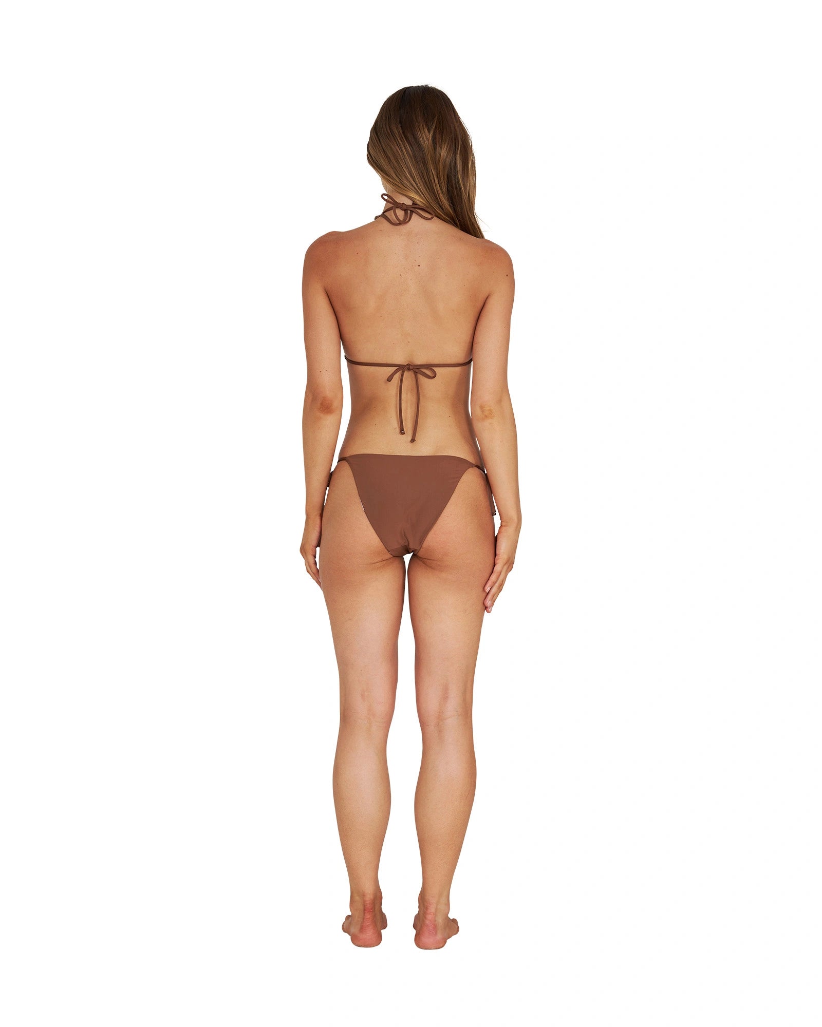 A woman wearing a brown one-piece swimsuit showing the back details. 