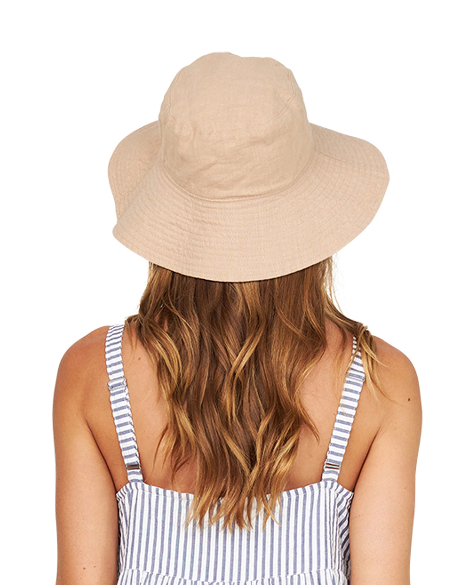 Back view of a female model wearing the Classic Okanui reversible bucket hat  in stone color