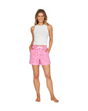 A female model wearing a crew neck tank top and pink shorts.