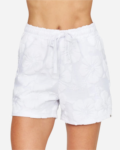 A simple white short with a pattern of hibiscus flowers and a two side pockets. 