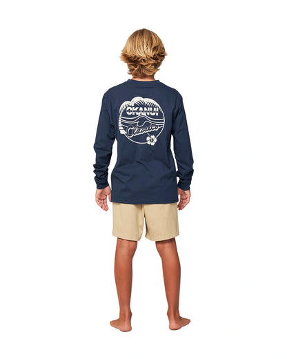 Full body back view of a boy wearing the Okanui classic badge long sleeve T-shirt in Navy