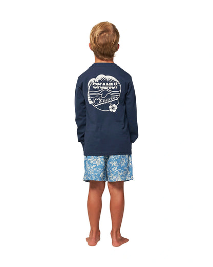 Full body back view of a little boy wearing the Okanui classic badge long sleeve T-shirt in Navy