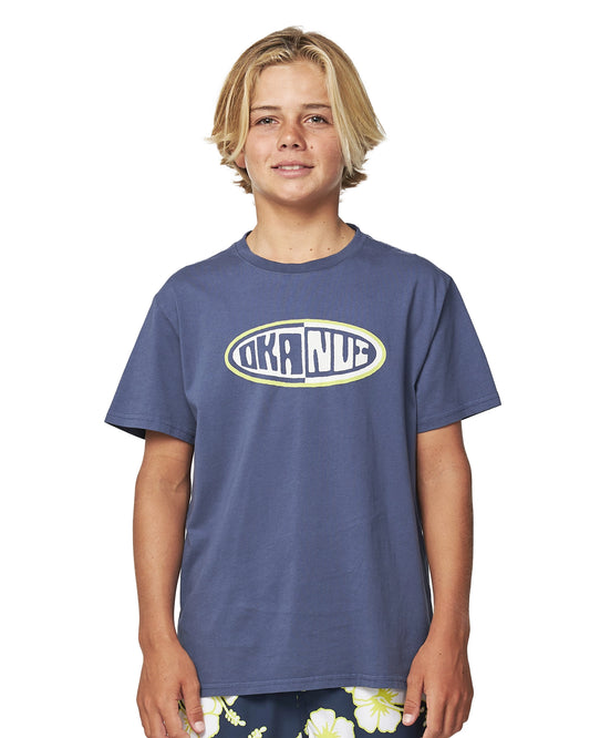 Close up front view of a boy wearing the Okanui Kids Deck Tee T-shirt in Washed Navy