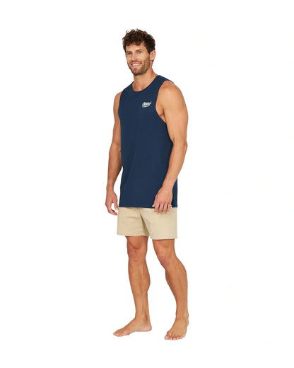 A male model slightly posing sideways wearing the Okanui Big Screen Tank in Navy.