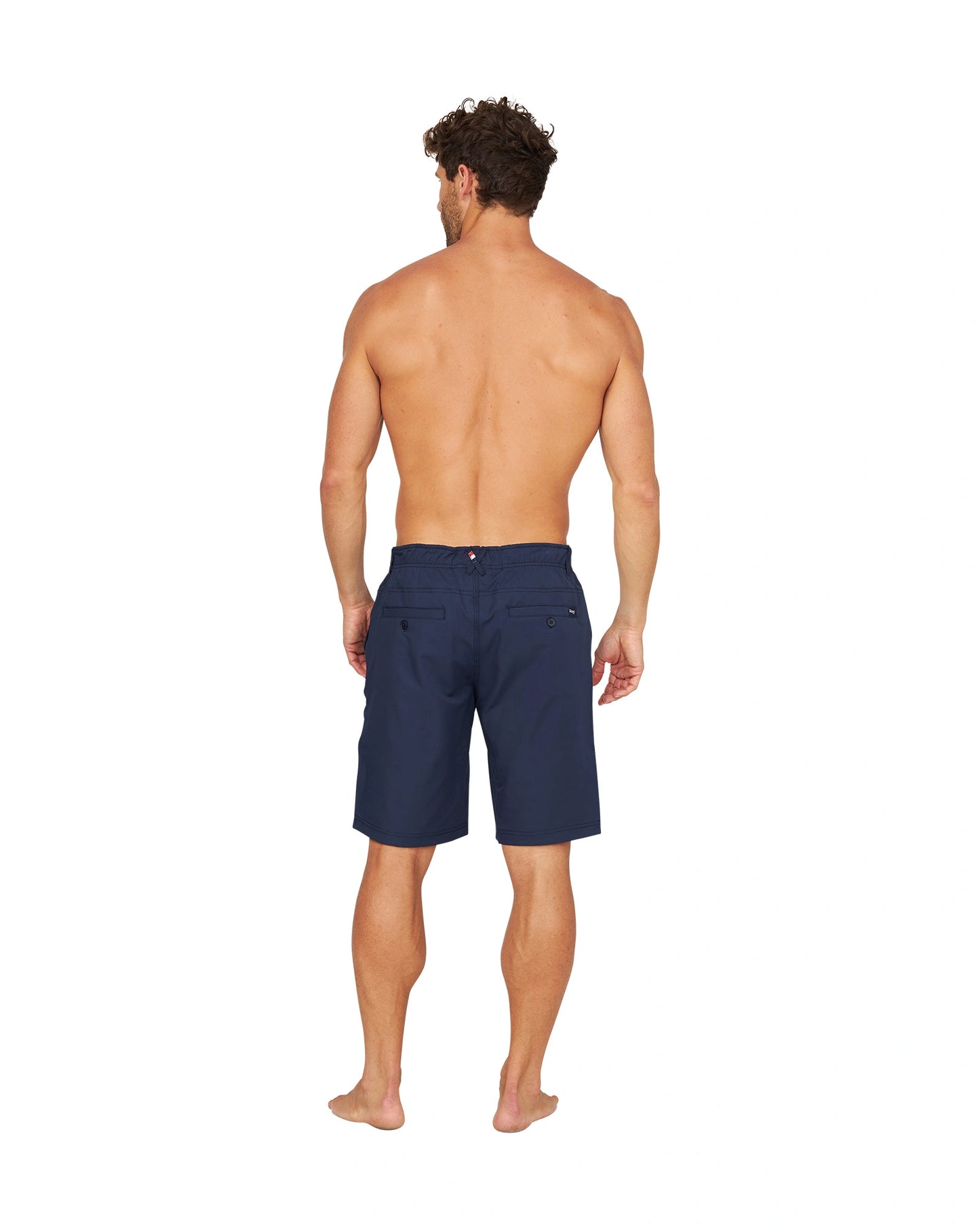 Full back view of a shirtless male model wearing the Okanui Active Byrd Golf Shorts in navy.