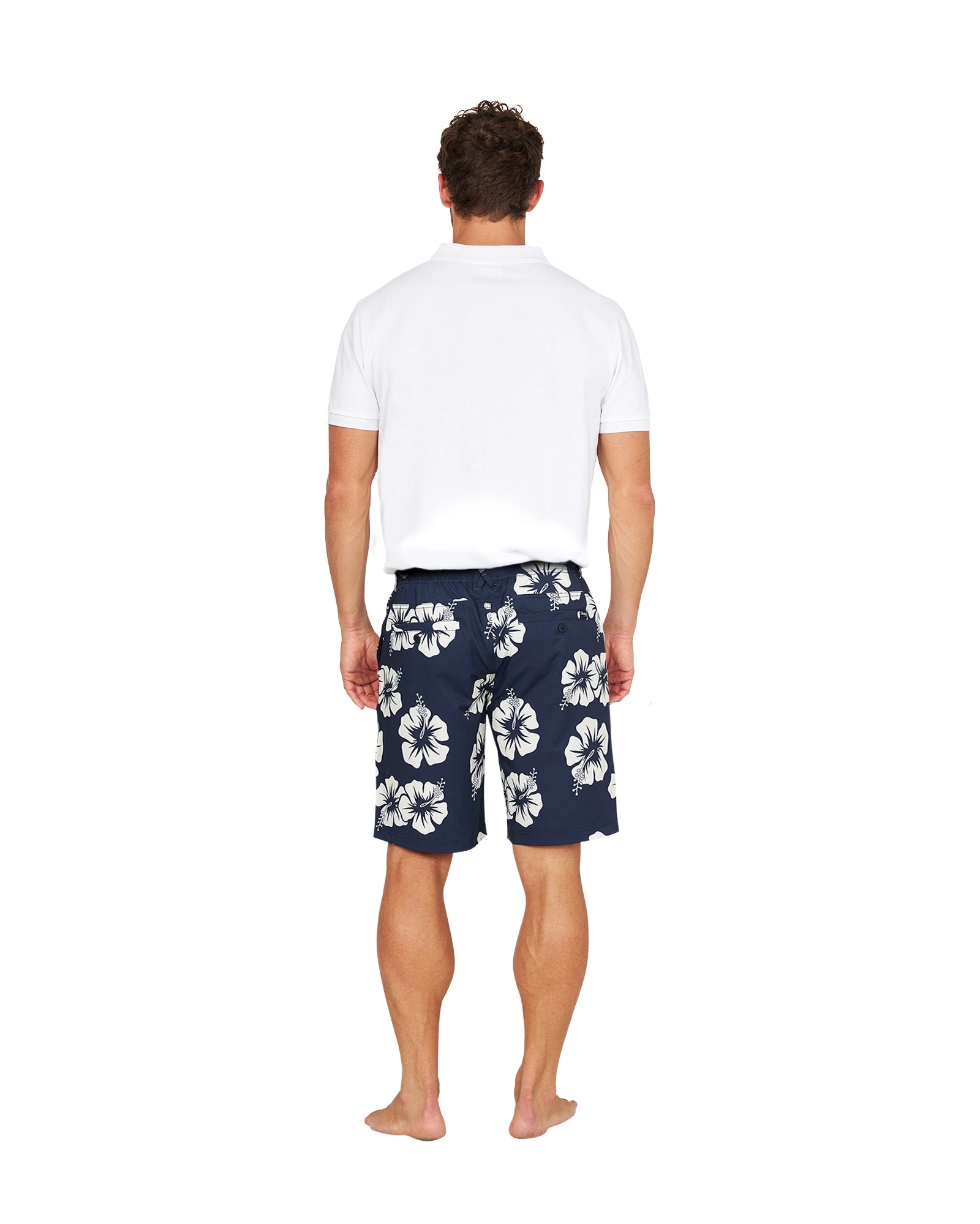 Full back view of a male model wearing the Okanui Active Byrd Golf Shorts in navy stone color.