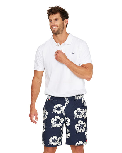 A male model wearing the Okanui Active Byrd Golf Shorts in navy stone color.