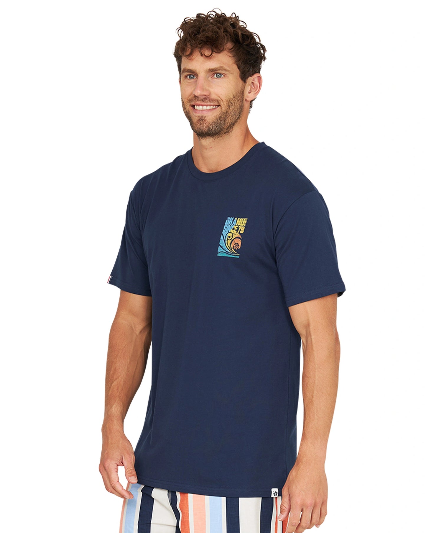 A front slightly side view of a male model wearing the Okanui Full Set T-Shirt in navy color.