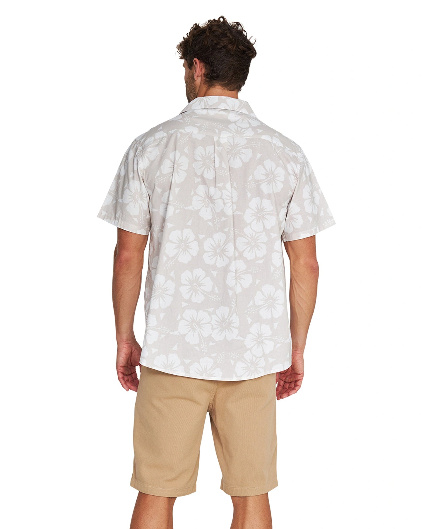 Back view of a male model wearing the Okanui Classic Button up short sleeve shirt in Hibiscus Stone