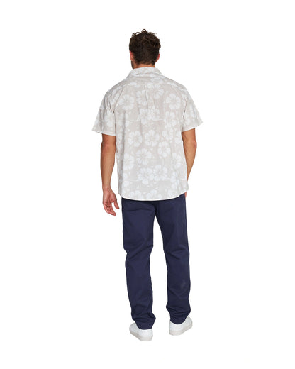 Full body back view of a male model wearing the Okanui Classic Button up short sleeve shirt in Hibiscus Stone