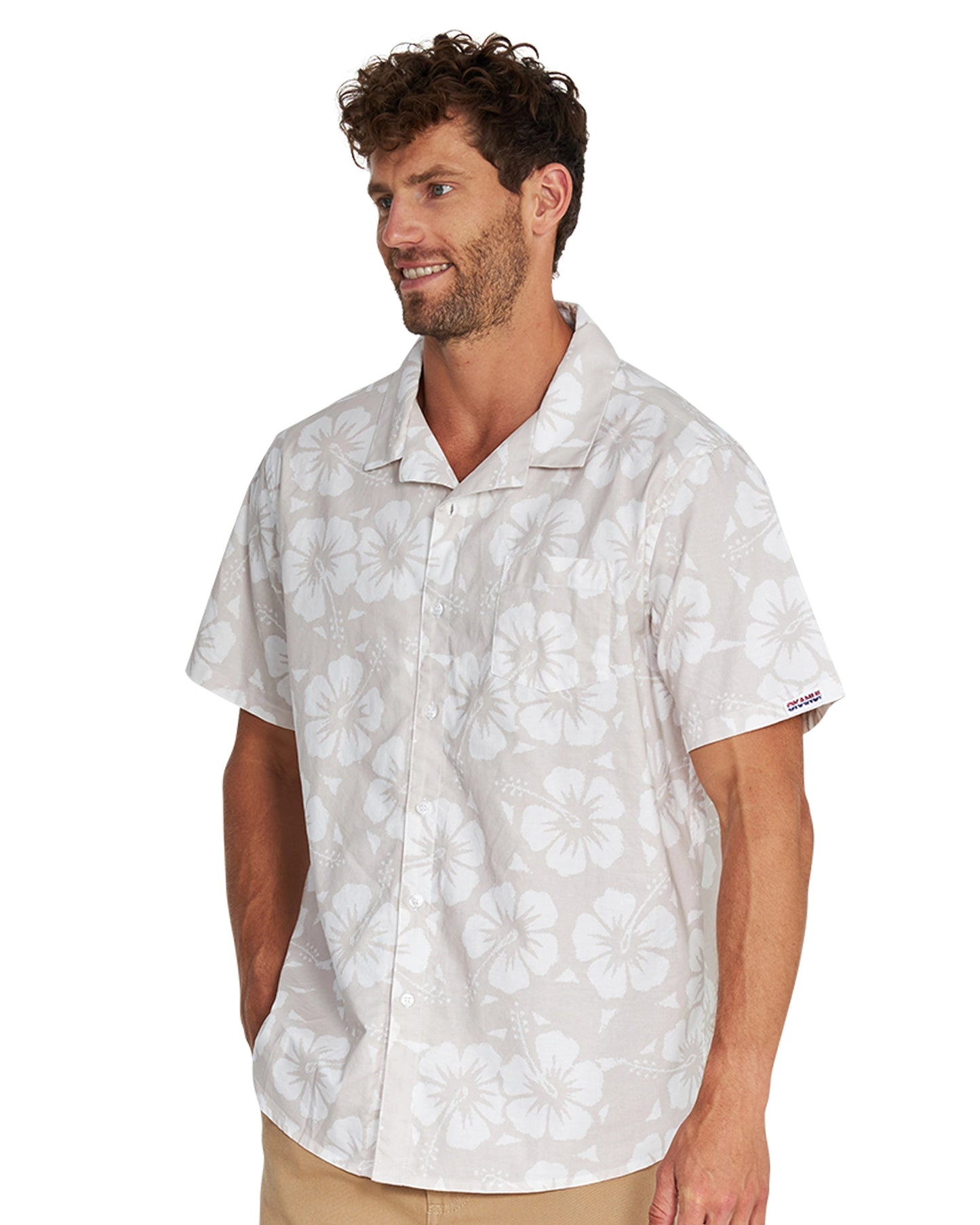 Angled left side view of a male model wearing the Okanui Classic Button up short sleeve shirt in Hibiscus Stone