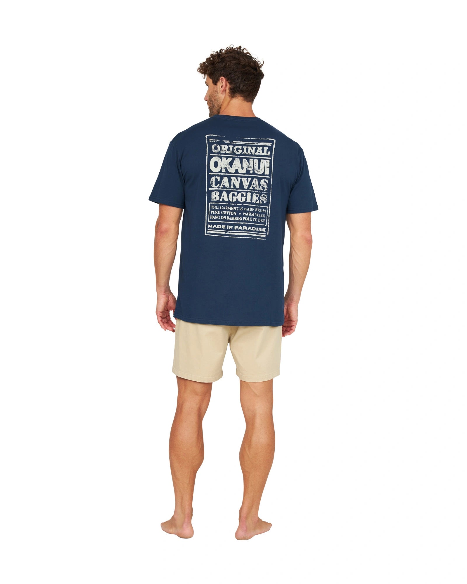 Full back view of a male model wearing the Okanui OG Baggies T-Shirt in navy.