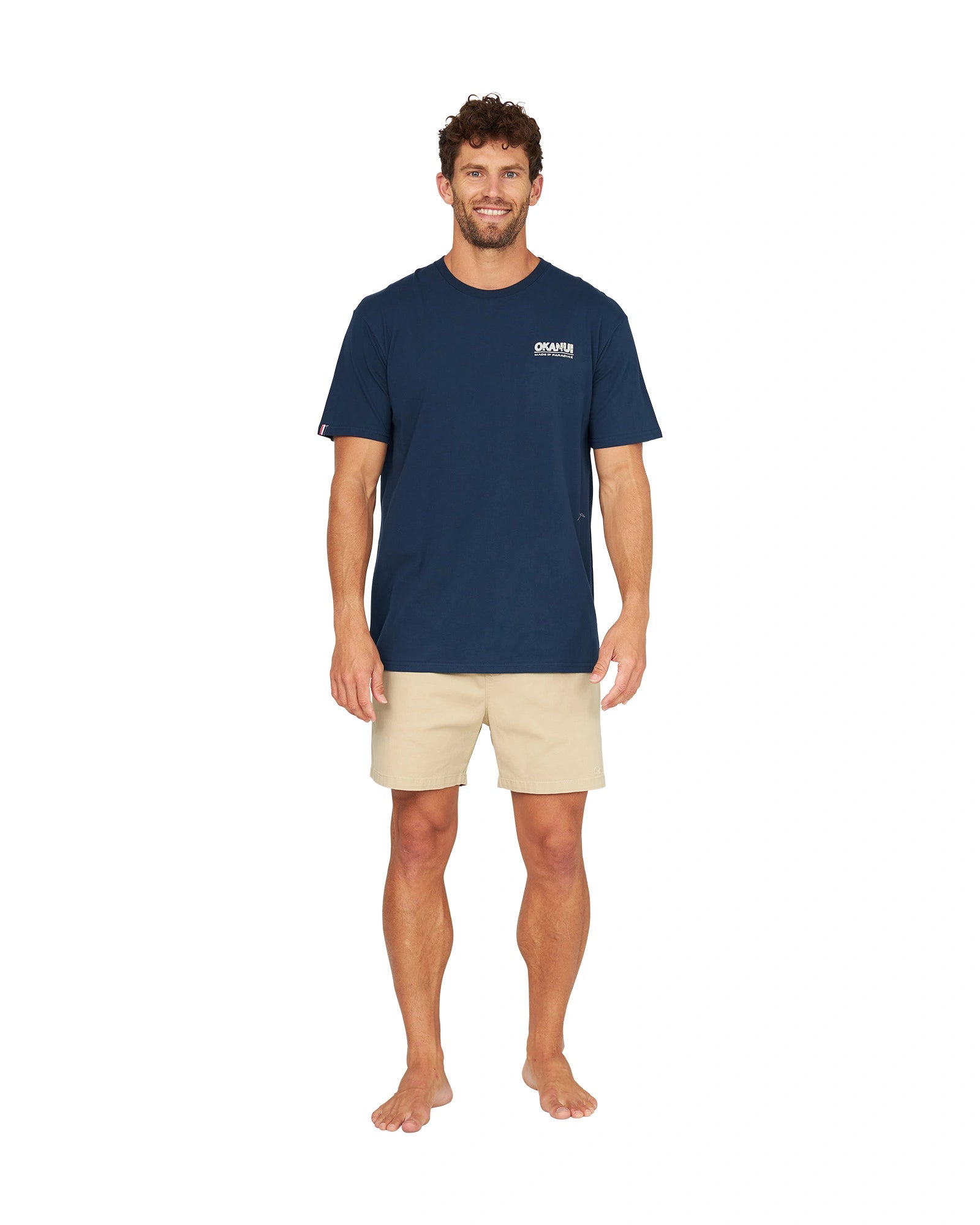 A male model wearing the Okanui OG Baggies T-Shirt in navy.